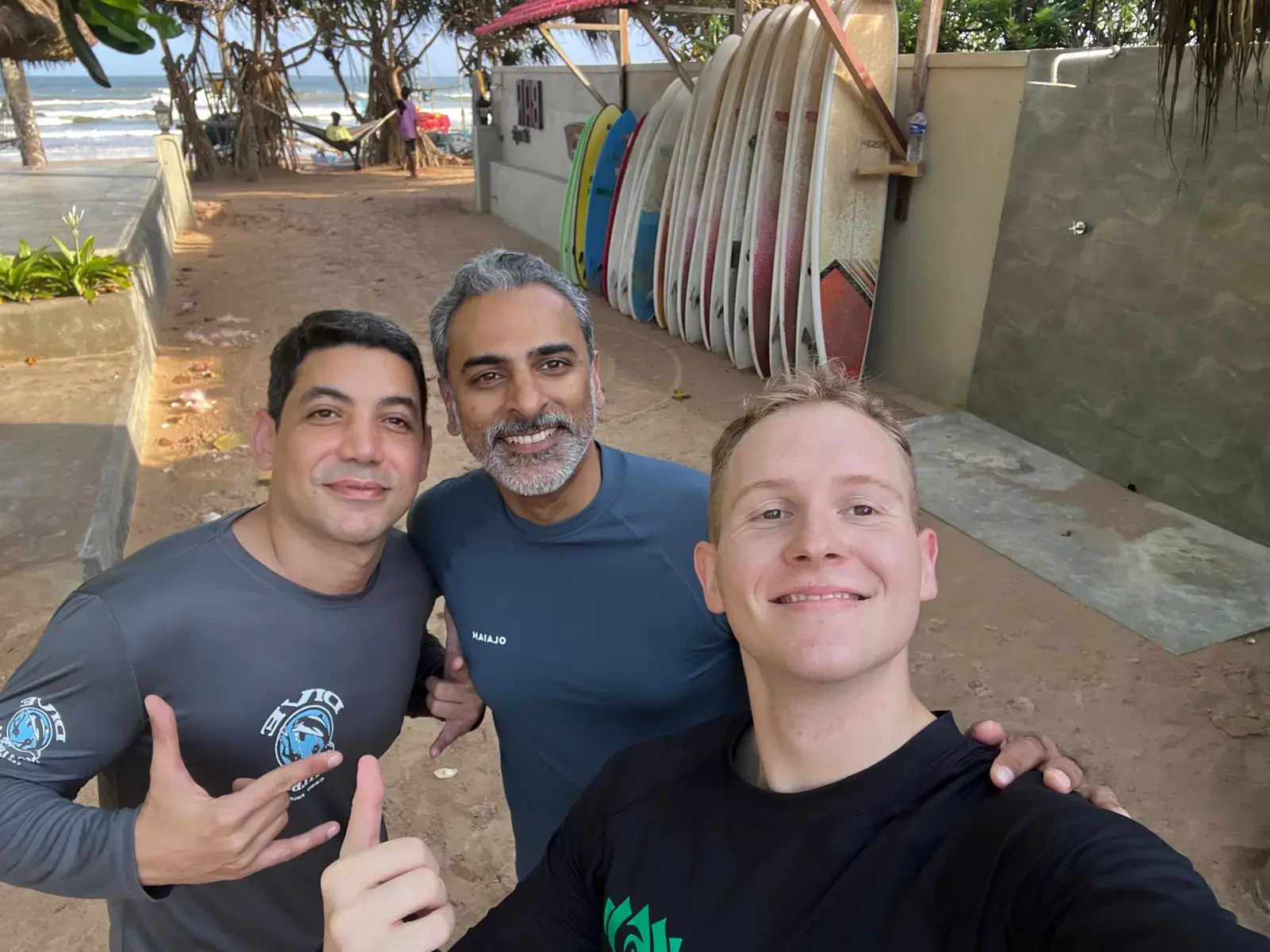 Three guests smiling for a selfie by the board rack