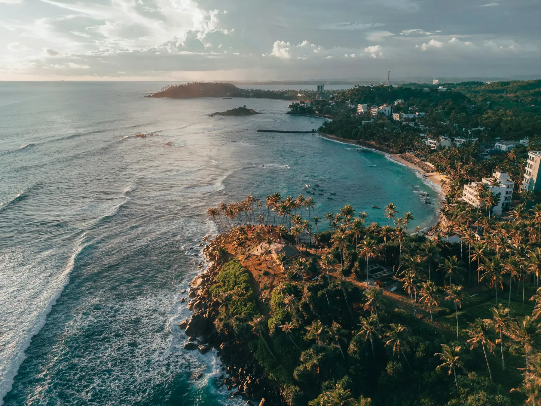 Aerial view of Mirissa’s palm-covered headland and bay